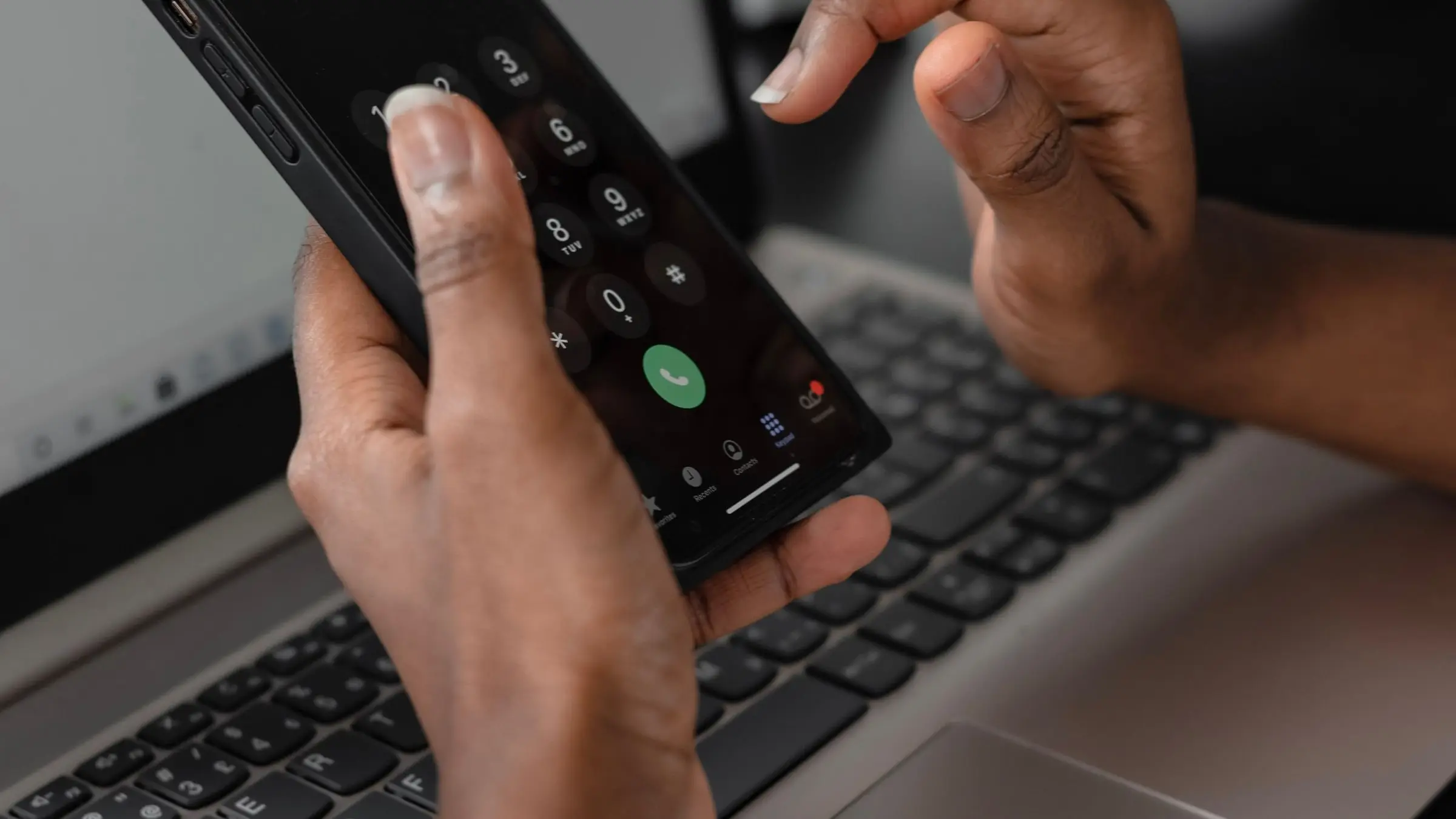 Hands dialing a phone