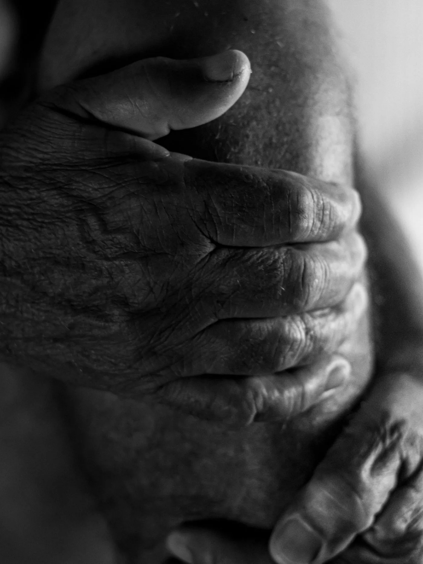 An older man pressing both hands to a painful knee